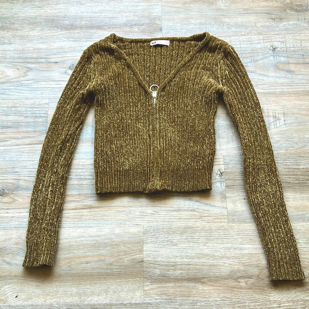 Olive green v-neck sweater with a wide ribbed pattern with a silver zipper.